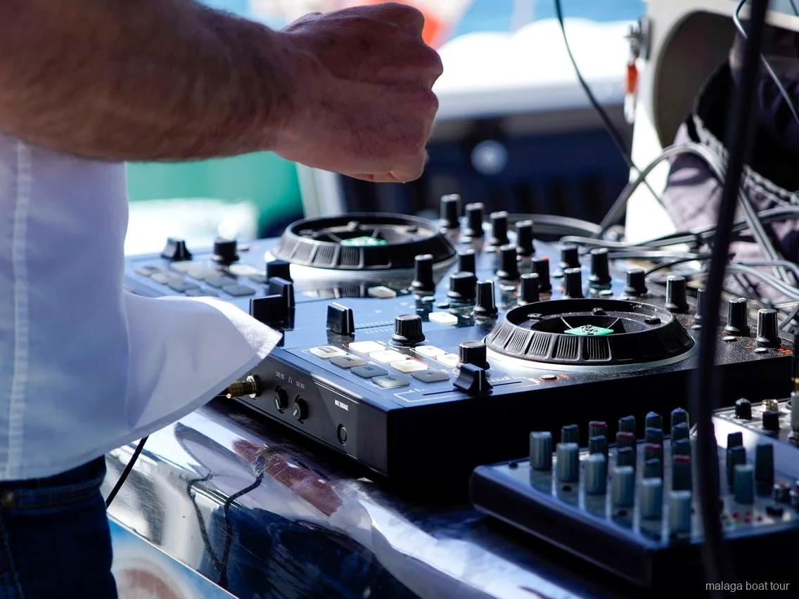 DJ controller and mixer set up on deck for music on a Malaga boat tour