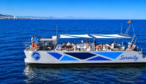 Catamaran searching for dolphins during the Malaga dolphin watching catamaran cruise