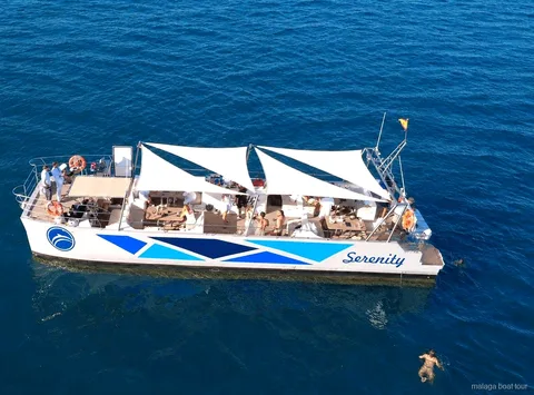 Aerial view of the Serenity catamaran with white sail awnings on a Malaga boat tour