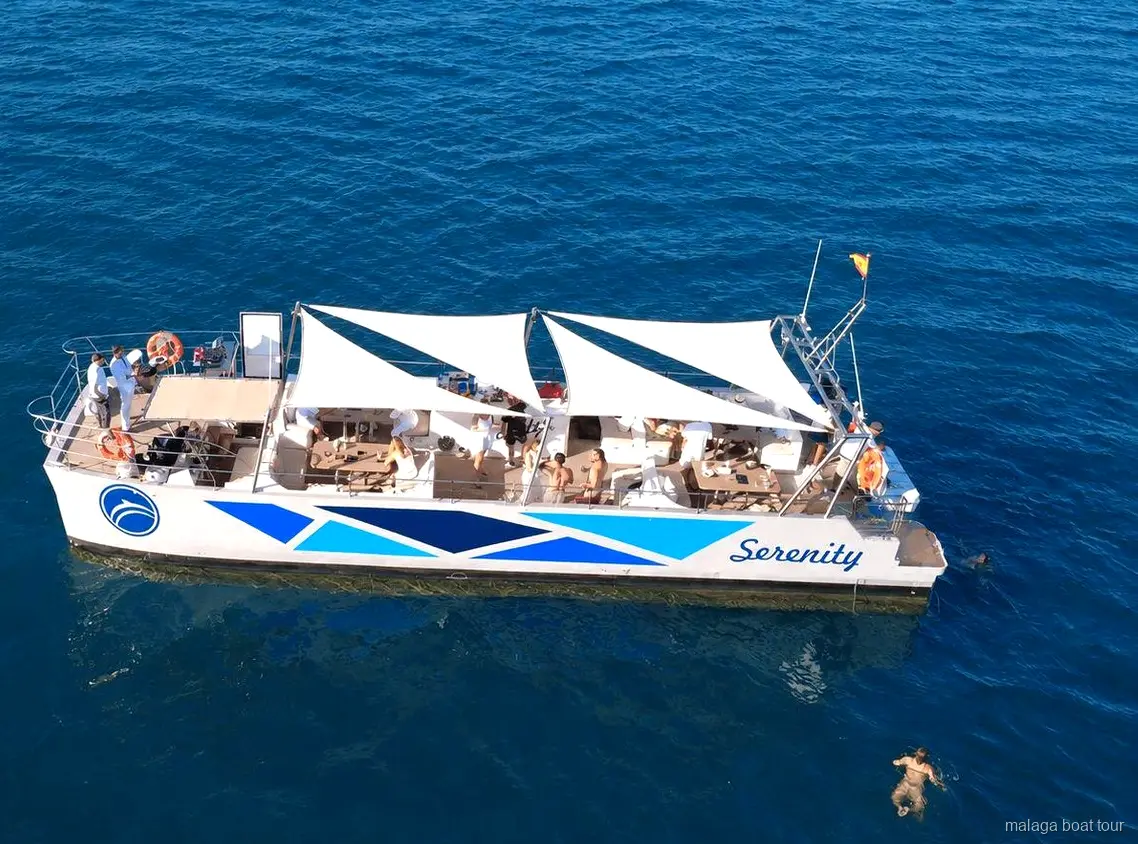 Aerial view of the Serenity catamaran with white sail awnings on a Malaga boat tour