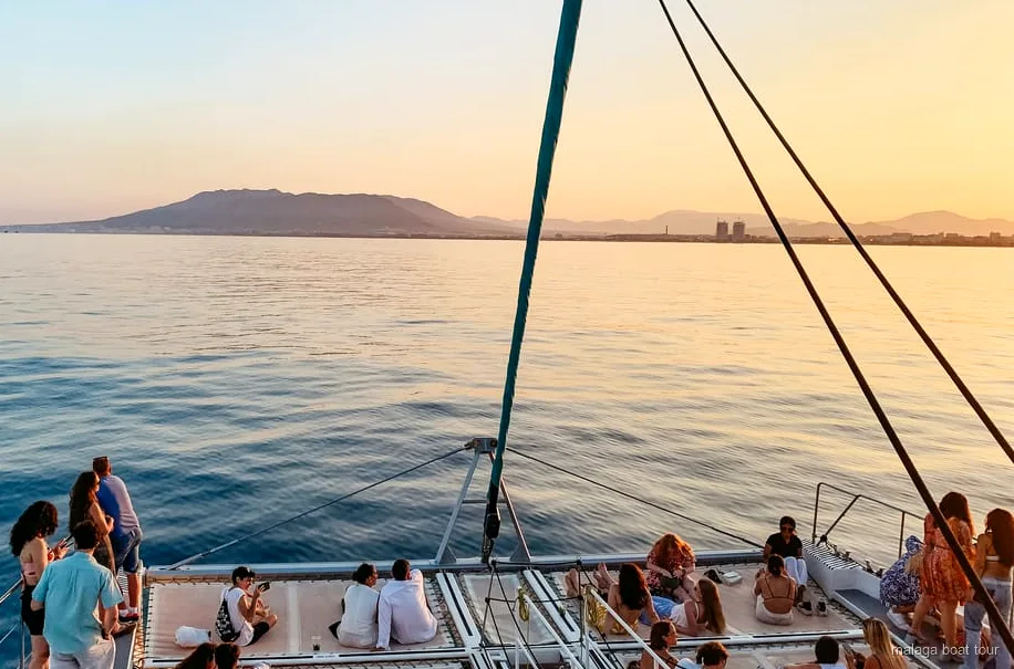 Catamaran sailing Malaga Bay at sunset during the Malaga sunset catamaran cruise
