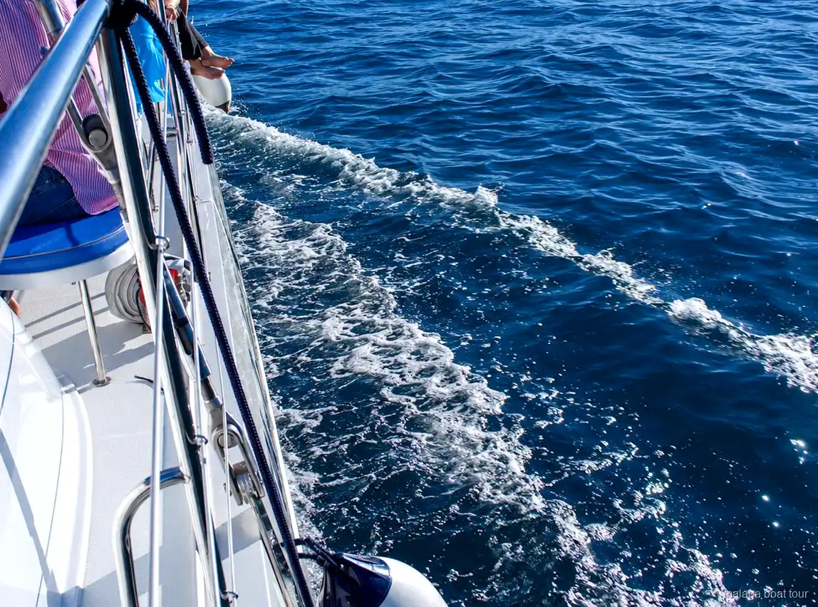Estela d'escuma al costat del casc d'un catamarà sobre aigua blava durant un malaga boat tour